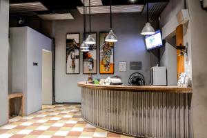 a bar in a restaurant with a counter and lights at FRii Bali Echo Beach in Canggu