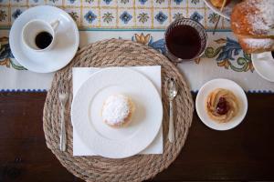 a table with a plate of food and a cup of coffee at Casa Dei Vettii B&B in Pompei Scavi