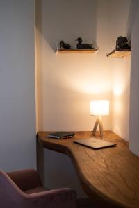 a desk with a lamp on top of it at Casa Dei Vettii B&B in Pompei Scavi