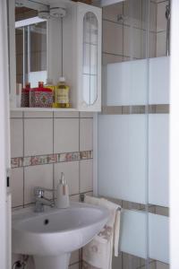 a white bathroom with a sink and a mirror at Casa Dei Vettii B&B in Pompei Scavi