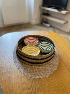 three bowls sitting on top of a table at Canopée - Appartement - Hyper centre ville in Quimper