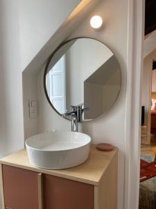 a bathroom with a white sink and a mirror at Canopée - Appartement - Hyper centre ville in Quimper