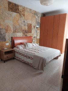 a bedroom with a bed and a cabinet and a table at Mi isla bonita in Arrecife
