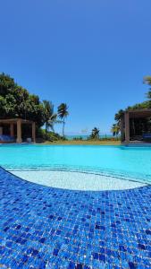 a swimming pool with blue tiles on the ground at BRISA DE CARAPIBUS in Conde