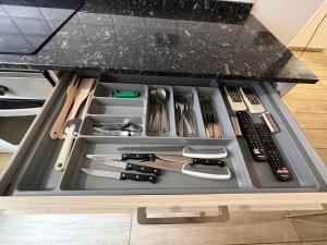 a drawer filled with cooking utensils on a counter at luminoso apartamento 6 personas pueblo nuevo in Madrid