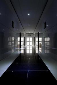 a hallway of a building with a large window at Mosaly Residence Caboma in Cotonou