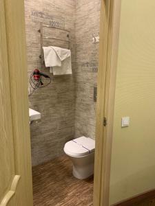 a small bathroom with a toilet and a sink at Frapolli Hotel in Odesa