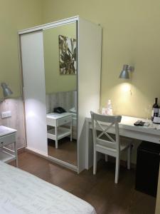 a bedroom with a mirror and a desk and a bed at Frapolli Hotel in Odesa