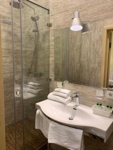 a bathroom with a sink and a shower at Frapolli Hotel in Odesa