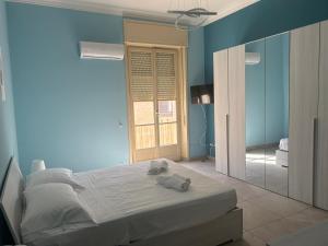 a blue bedroom with a bed and a mirror at Dimora Sant'Agata in Catania