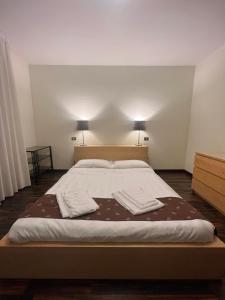ein Schlafzimmer mit einem großen Bett mit zwei Handtüchern darauf in der Unterkunft Appartamento Malpigihi 40 in Arezzo
