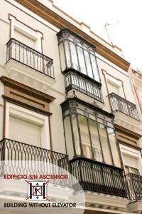 un edificio con balcones en un lateral en Las Atarazanas - Design Hostal, en Sevilla