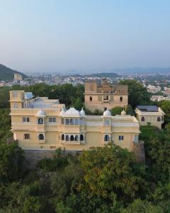 a large house on top of a hill at Titardi Garh- 18th Century Castle Homestay in Udaipur
