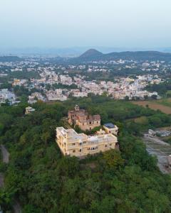 an aerial view of a building on a hill at Titardi Garh- 18th Century Castle Homestay in Udaipur