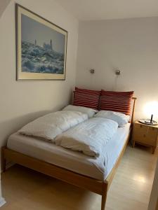 a bed in a bedroom with a picture on the wall at Wohlfühlort in Felde bei Kiel in Felde