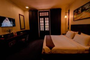 Rúm í herbergi á Hotel Nippon Colombo