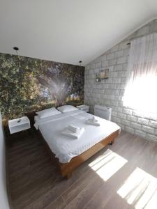 Postel nebo postele na pokoji v ubytování Apartmani Drijen