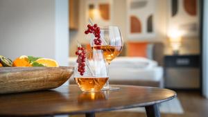 due bicchieri da vino seduti su un tavolo di legno di KULA Comfort Rooms a Villach Altre 16 foto