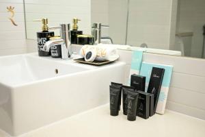 a bathroom with a counter with a sink with a counter at 1BR Apartment Retreat for Your Getaway In Al Muneera in Abu Dhabi