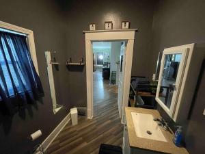 a bathroom with a sink and a mirror at Cozy Haven Retreat in Saint Marys