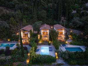 an aerial view of a house with a pool at night at Ionian Dream Villas in Lefkada Town