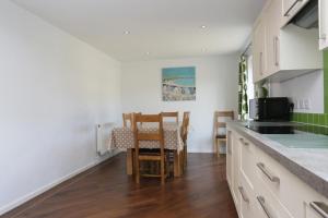 a kitchen with a table and chairs in a room at BOURNECOAST: Stones throw from the Quay - HB5666 in Bournemouth