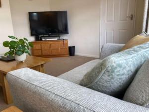 a living room with a couch and a flat screen tv at BOURNECOAST: Stones throw from the Quay - HB5666 in Bournemouth
