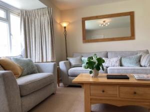 a living room with a couch and a table at BOURNECOAST: Stones throw from the Quay - HB5666 in Bournemouth