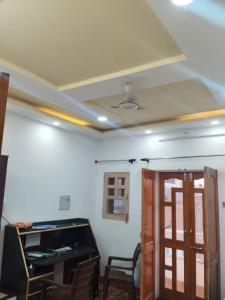 a room with a ceiling with a table and chairs at AB guest house { home stay} in Bikaner