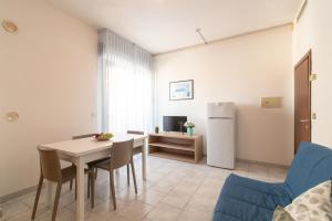 a kitchen and dining room with a table and a refrigerator at Residence Baltic in Cattolica