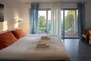 a bedroom with a large bed with two towels on it at Ionian Dream Villas in Lefkada Town