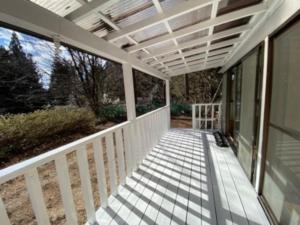 a porch of a house with a pergola at 森の中のぽつんとワンワン別荘 in Nikko