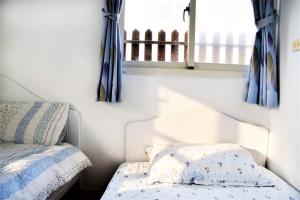 Postel nebo postele na pokoji v ubytování Caramel Macchiato Homestay