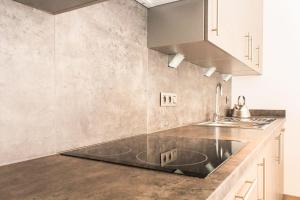 a kitchen with a sink and a counter top at Cocoon by Jeanne - op 450m van B&B Jeanne in Nieuwpoort