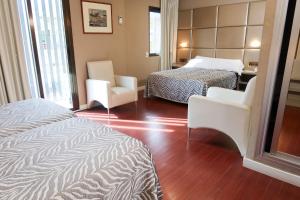 Postel nebo postele na pokoji v ubytování Hotel Benetusser