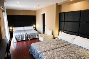 Postel nebo postele na pokoji v ubytování Hotel Benetusser