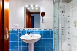 a bathroom with a sink and a shower at Center of Seville! Luxury apartment in Sevillian Manor House! in Seville +23 photos