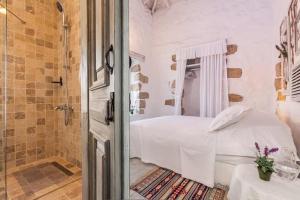 a white bedroom with a bed and a shower at YUKARI SOKAK VİP BUTİK OTEL in Alacati