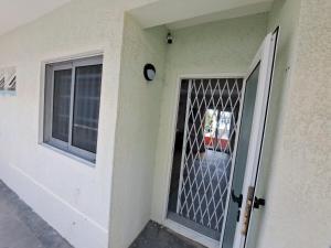 a door with a grill on the side of a house at Plein Soleil in Grand-Baie +9 photos