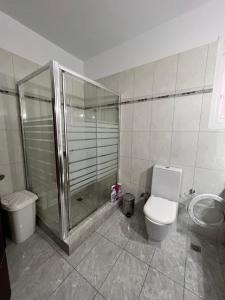 a bathroom with a shower and a toilet and a sink at KONTIS' Luxury Detached house near the sea in Loutraki