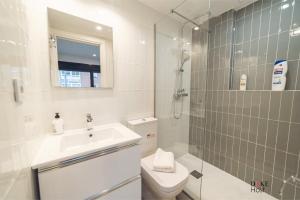 a bathroom with a toilet and a sink and a shower at CASTILLA LUXURY A Apartments in Madrid