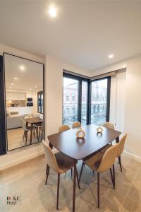 a dining room with a table and chairs at CASTILLA LUXURY A Apartments in Madrid