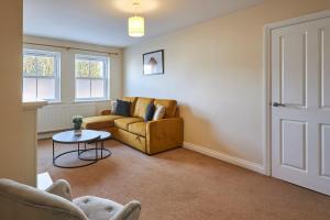 a living room with a couch and a table at Host & Stay - Tibshelf House in Tibshelf