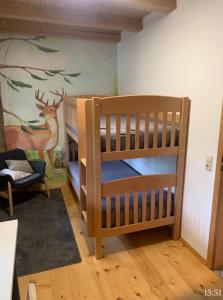 a room with two bunk beds and a mural at Moarhof Ferienwohnung1 in Dietramszell