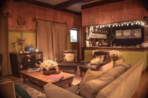 a living room with a couch and a table at Los Juncos Patagonian Lake House in San Carlos de Bariloche