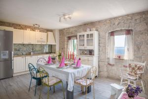 a kitchen with a table with pink napkins on it at Holiday home Fetiva Makar in Makarska