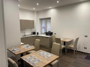 une cuisine et une salle à manger avec des tables et des chaises dans l'établissement B&B La Villa Cittanova, à Cittanova