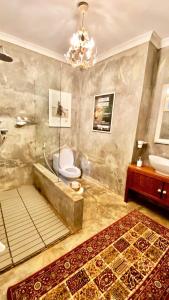 a bathroom with a tub and a toilet and a sink at Killi Bohemian Luxury in Moshi