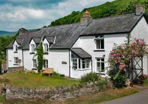 a white house with a black roof at Scenic Couples Getaway in the Brecon Beacons in Crickhowell