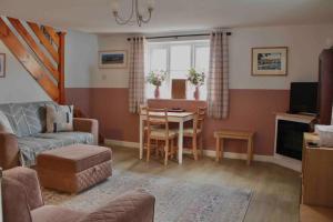 a living room with a couch and a table at Scenic Couples Getaway in the Brecon Beacons in Crickhowell